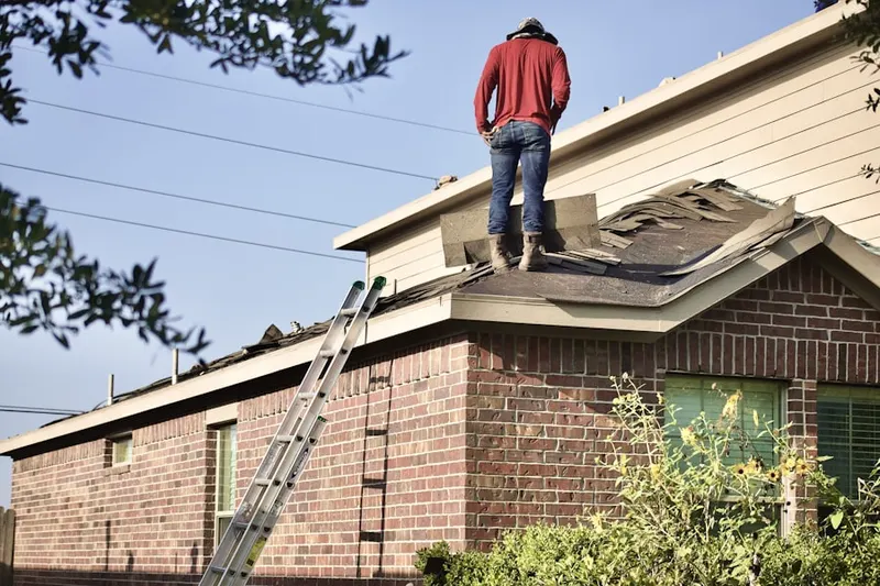 Professional roofer working on a residential roof in Burrillville